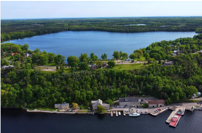 Aerial view of the lake, harbour, and surrounding community